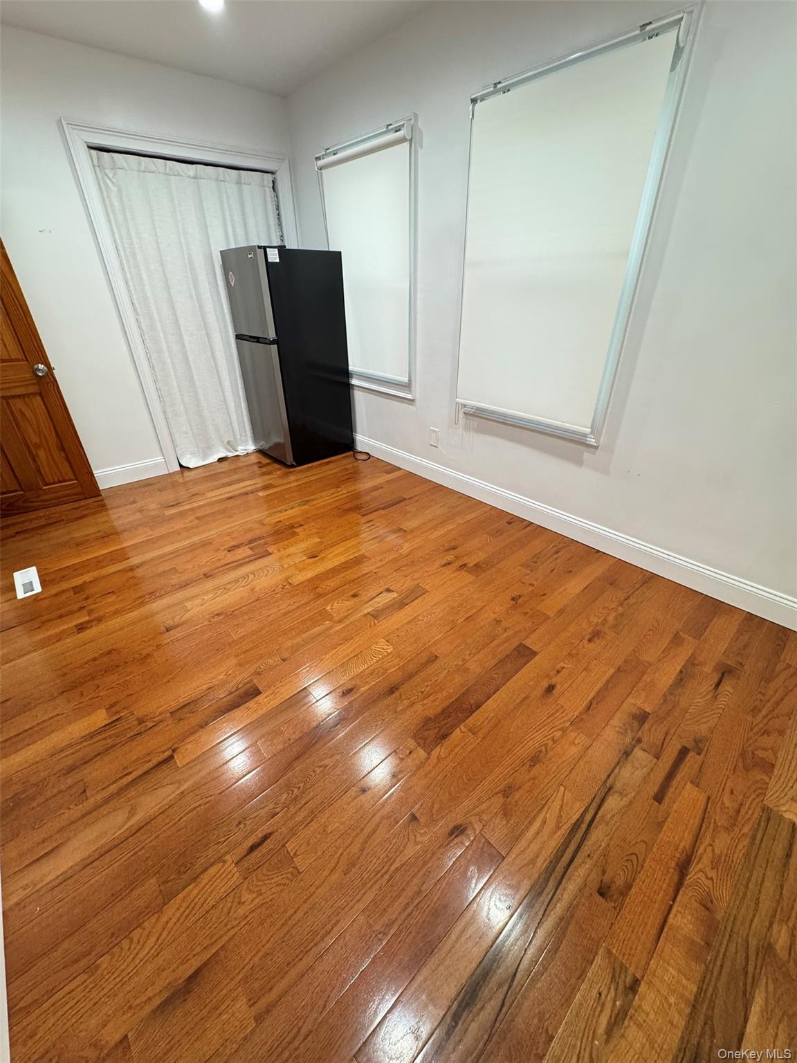 89-36 90th Street Queens, NY 11421 - Photo 11 of 17 a view of a livingroom with wooden floor