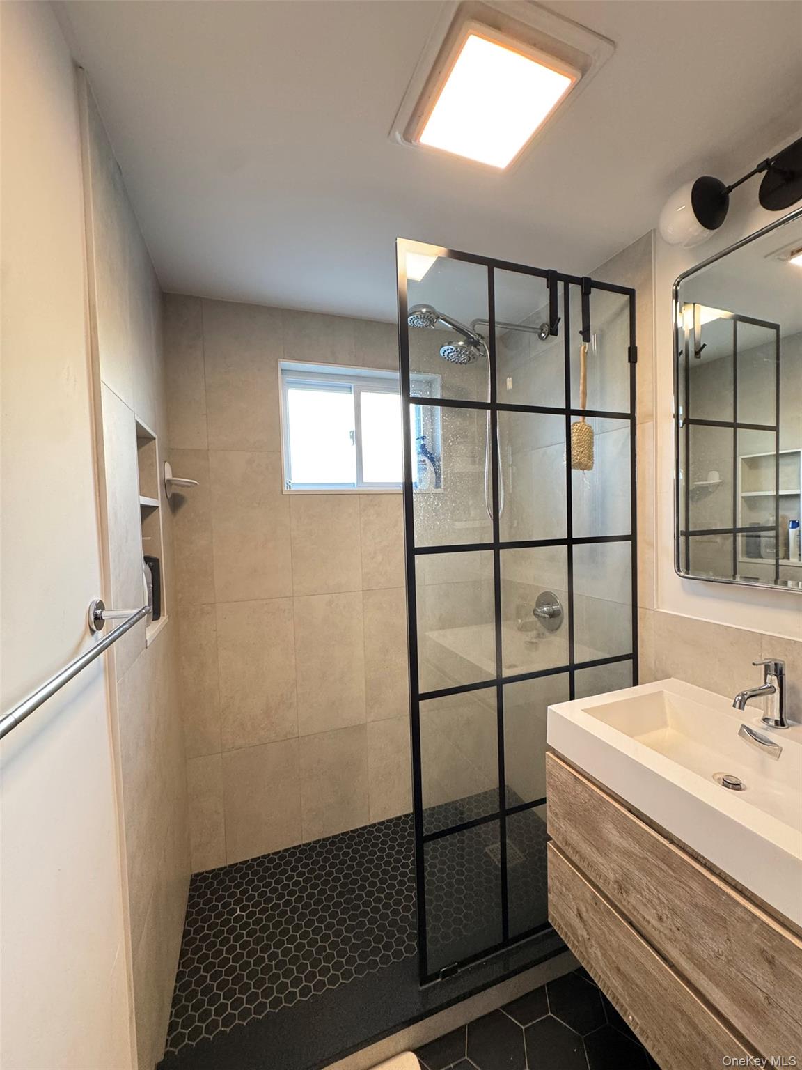 89-36 90th Street Queens, NY 11421 - Photo 12 of 17 a bathroom with a sink and a shower