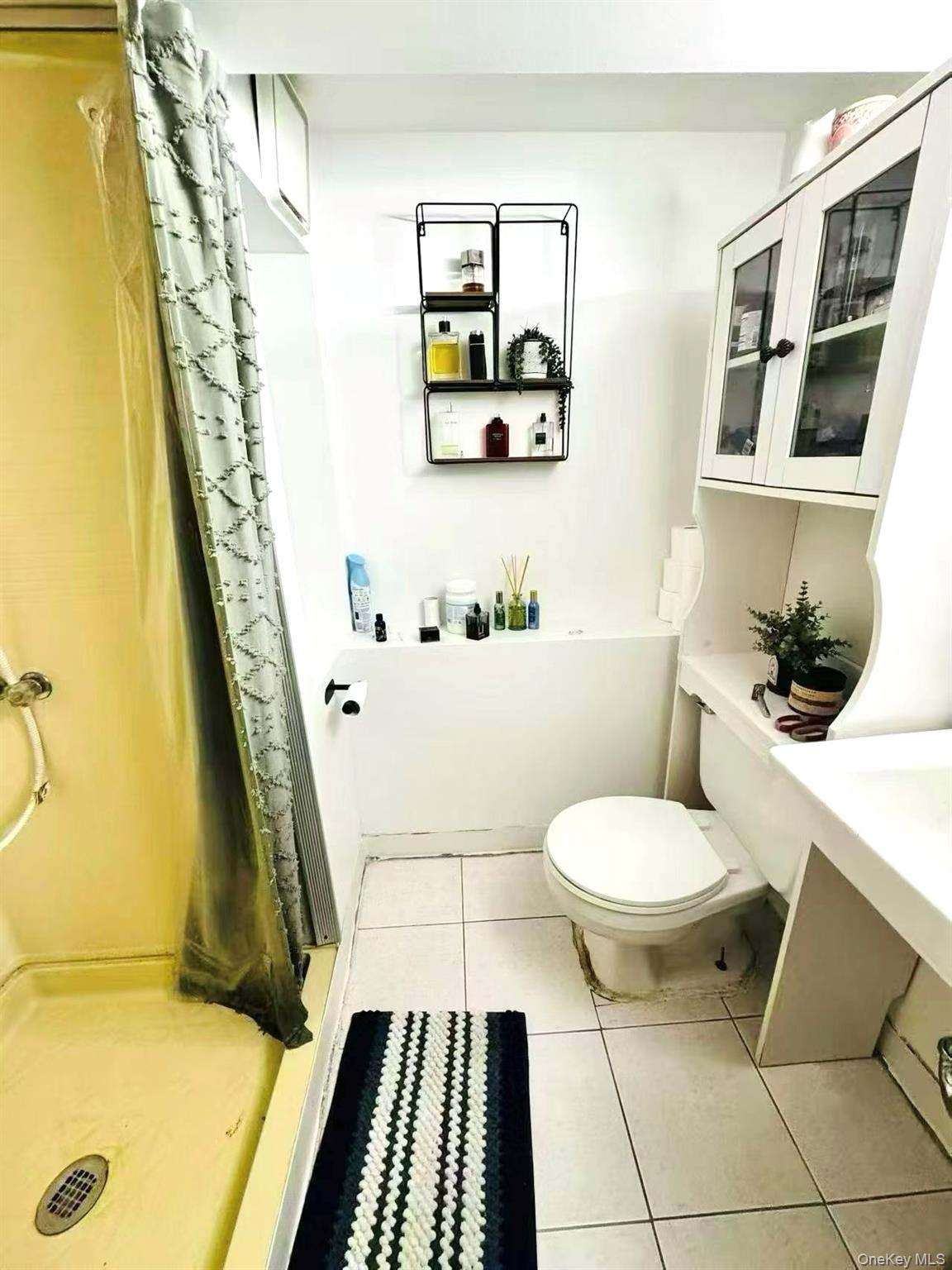 89-36 90th Street Queens, NY 11421 - Photo 16 of 17 a bathroom with a toilet and a shower