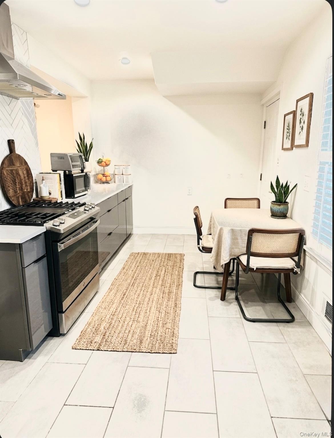 89-36 90th Street Queens, NY 11421 - Photo 4 of 17 a kitchen with a sink and a stove top oven
