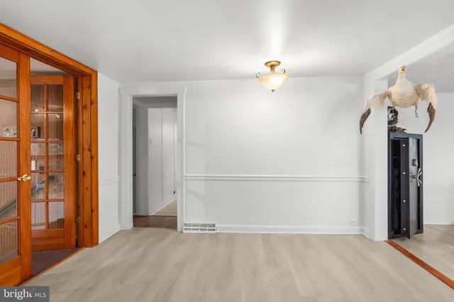 a view of a kitchen with a refrigerator a stove cabinets and a wooden floor