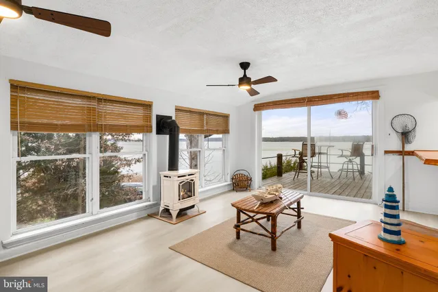 a living room with furniture and large windows
