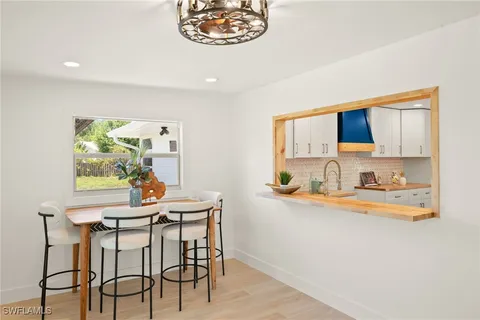 a view of a dining room with furniture and a kitchen