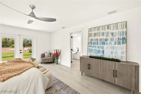 a bedroom with furniture and large windows