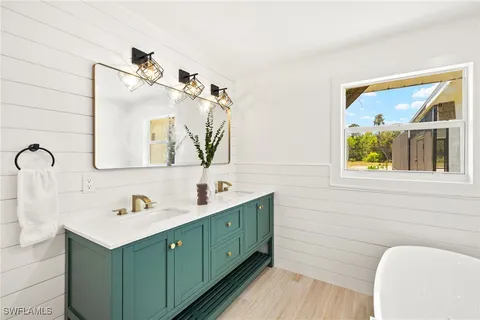 a bathroom with a double vanity sink mirror and