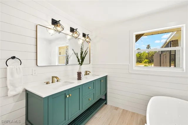 a bathroom with a double vanity sink mirror and