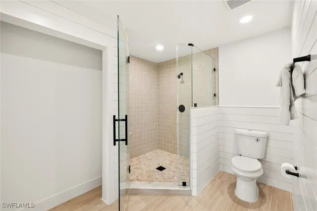 a bathroom with a shower and toilet