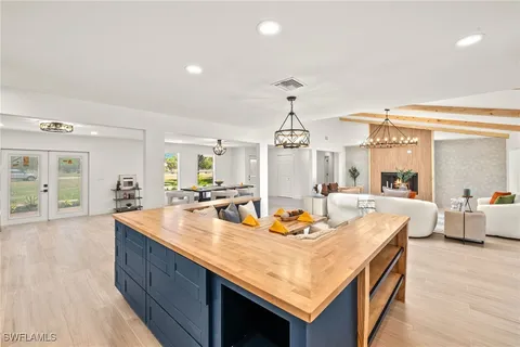 a view of a dining room and hall with wooden floor