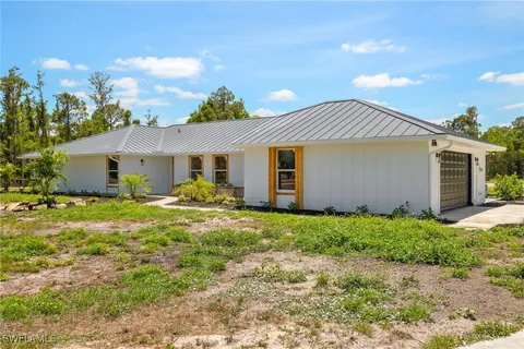 a view of a house with a backyard