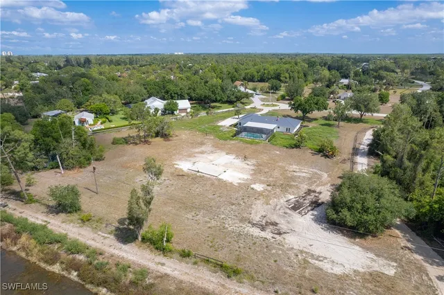 an aerial view of a houses with a yard