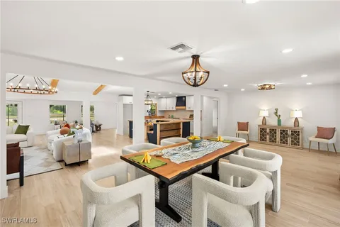 a living room with furniture kitchen view and a table