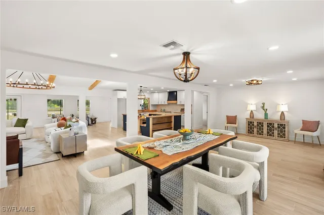 a living room with furniture kitchen view and a table