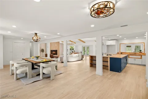 a living room with furniture a rug and kitchen view