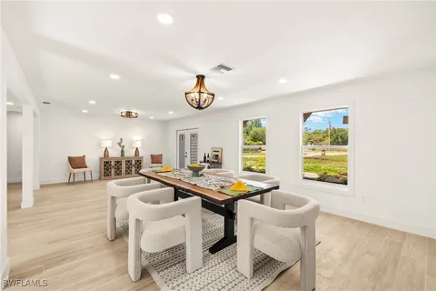 a dining room with furniture and window