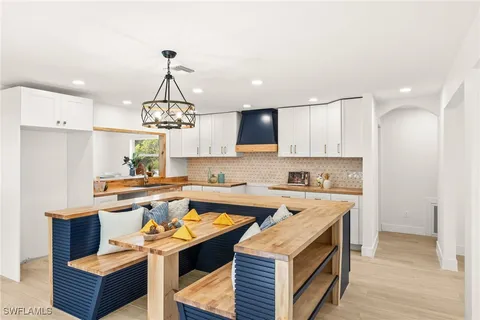 a kitchen with a sink a counter top space and stainless steel appliances