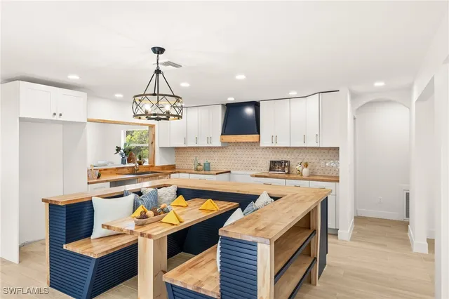 a kitchen with a sink a counter top space and stainless steel appliances
