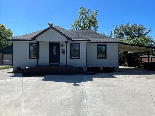 a house that has a tree in front of it