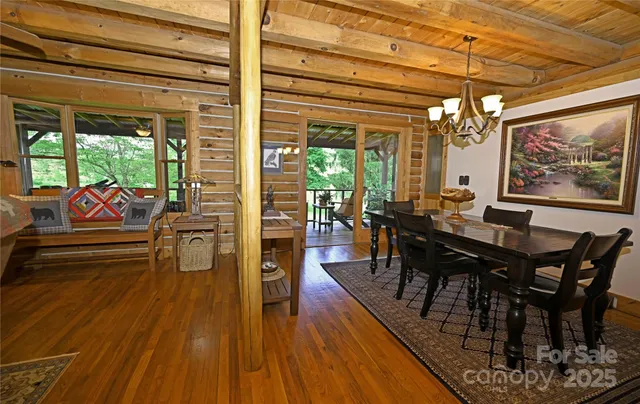 a view of a dining room with furniture wooden floor and a chandelier
