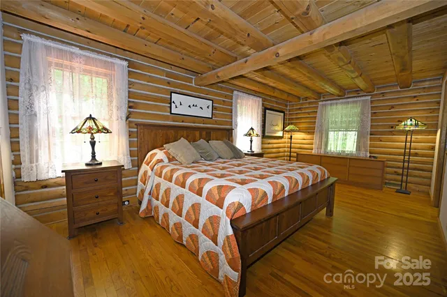 a bed sitting in a bedroom next to a window