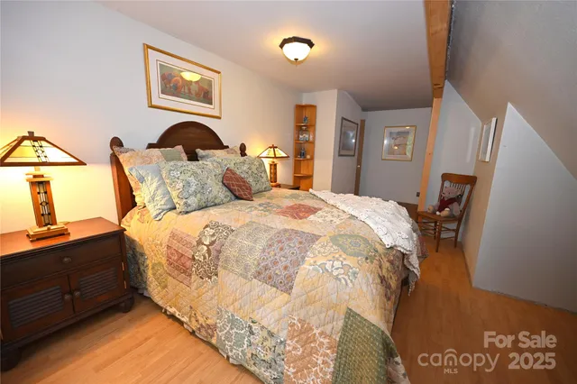 a bed sitting in a bedroom next to a window