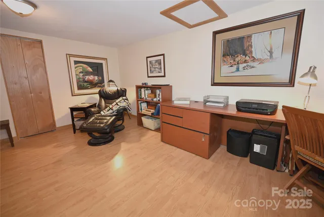 a dining room with furniture a chandelier and wooden floor