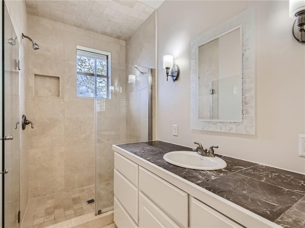 267 North Commons Ford Road Austin, TX 78733 - Photo 17 of 34 Full bathroom with vanity and a shower stall