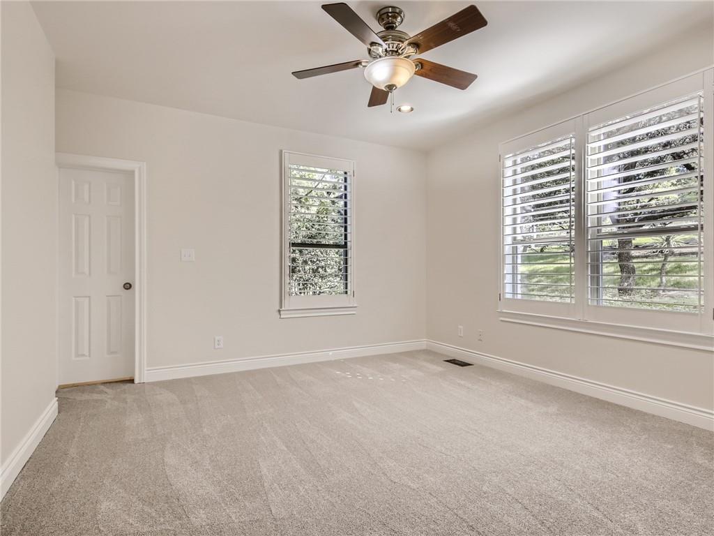 267 North Commons Ford Road Austin, TX 78733 - Photo 20 of 34 Unfurnished room with light colored carpet, a ceiling fan, and recessed lighting