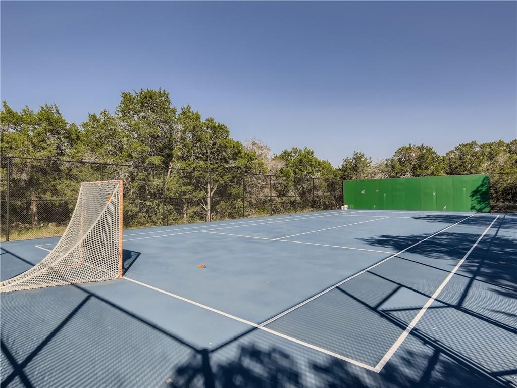 267 North Commons Ford Road Austin, TX 78733 - Photo 2 of 34 View of tennis court with an area for sports