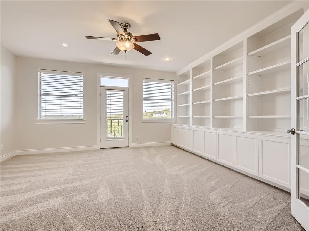 267 North Commons Ford Road Austin, TX 78733 - Photo 24 of 34 Spare room with light carpet, built in features, and ceiling fan