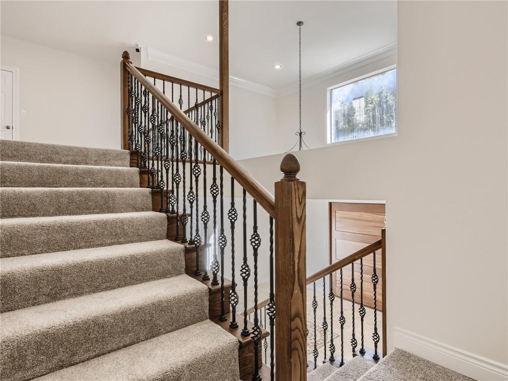 267 North Commons Ford Road Austin, TX 78733 - Photo 29 of 34 Stairs with ornamental molding and recessed lighting