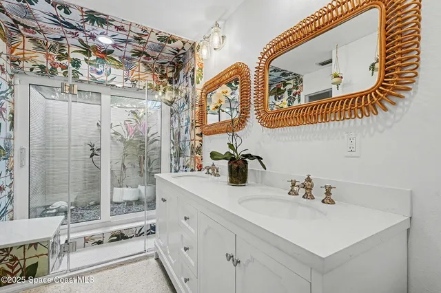 a bathroom with a sink a mirror and a shower