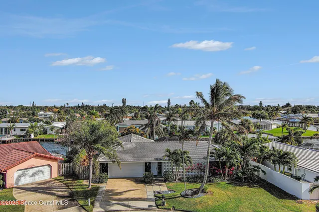 a view of residential houses with yard and swimming pool