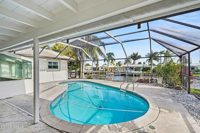 an aerial view of a houses with a lake view