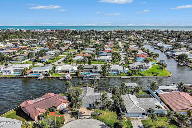 an aerial view of a houses with a lake