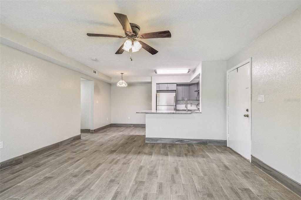 5111 Amulet Drive, Unit 104 New Port Richey, FL 34652 - Photo 11 of 74 wooden floor in an empty room with a window