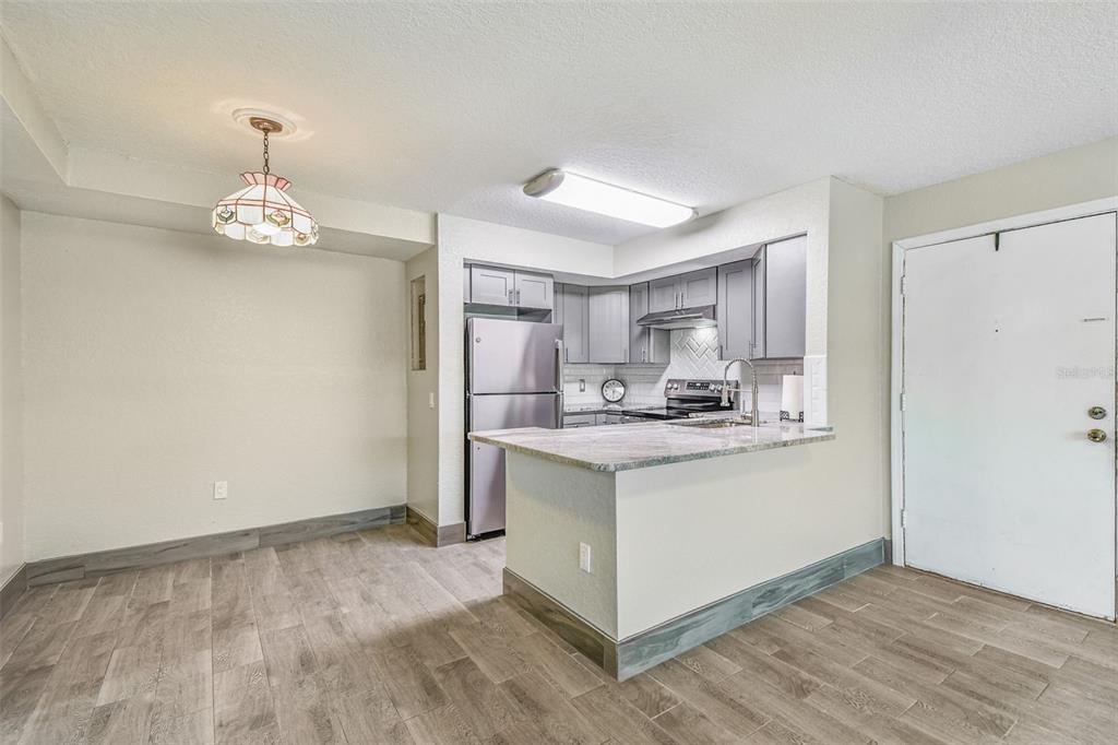5111 Amulet Drive, Unit 104 New Port Richey, FL 34652 - Photo 16 of 74 a kitchen with stainless steel appliances granite countertop a sink stove and refrigerator