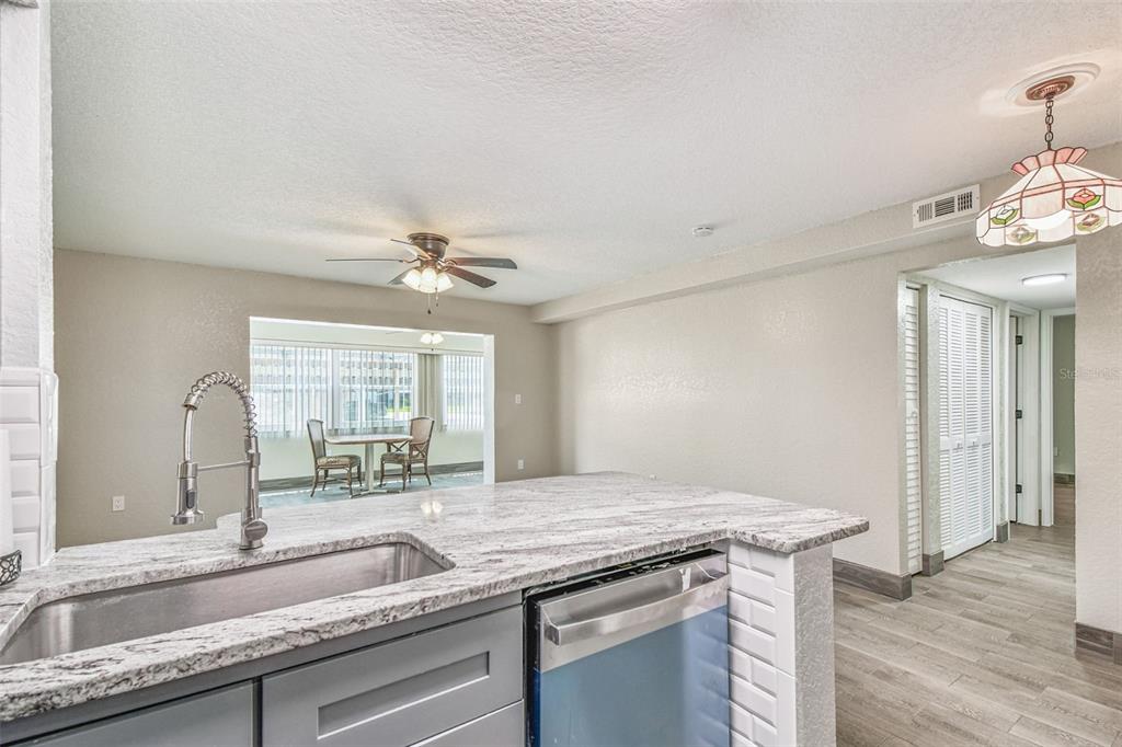 5111 Amulet Drive, Unit 104 New Port Richey, FL 34652 - Photo 23 of 74 a kitchen with a sink and a refrigerator