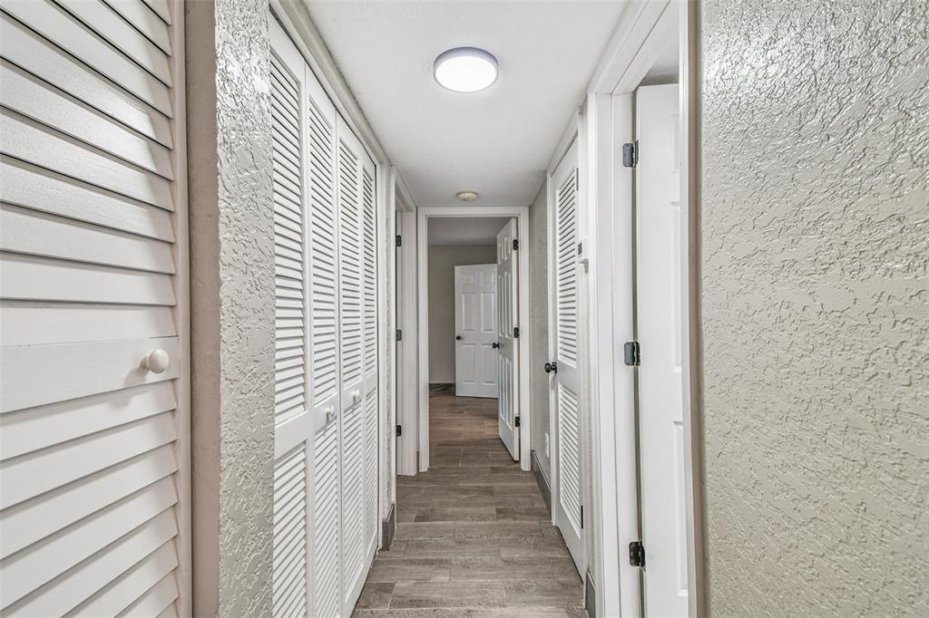 5111 Amulet Drive, Unit 104 New Port Richey, FL 34652 - Photo 24 of 74 a view of a hallway with wooden floor and staircase