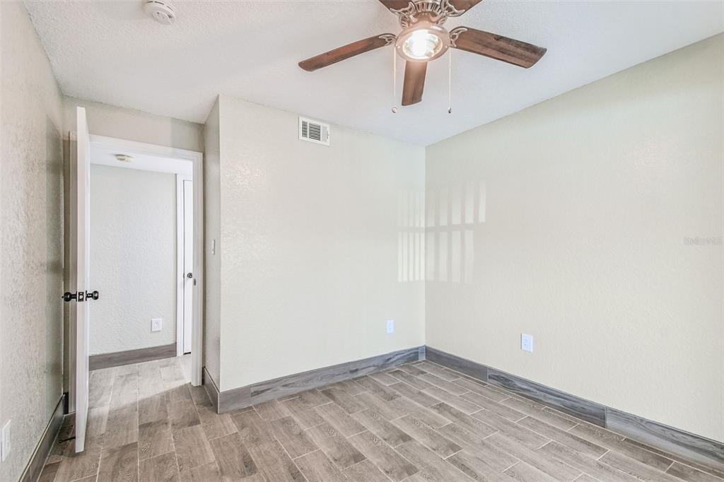 5111 Amulet Drive, Unit 104 New Port Richey, FL 34652 - Photo 28 of 74 an empty room with a ceiling fan and a window