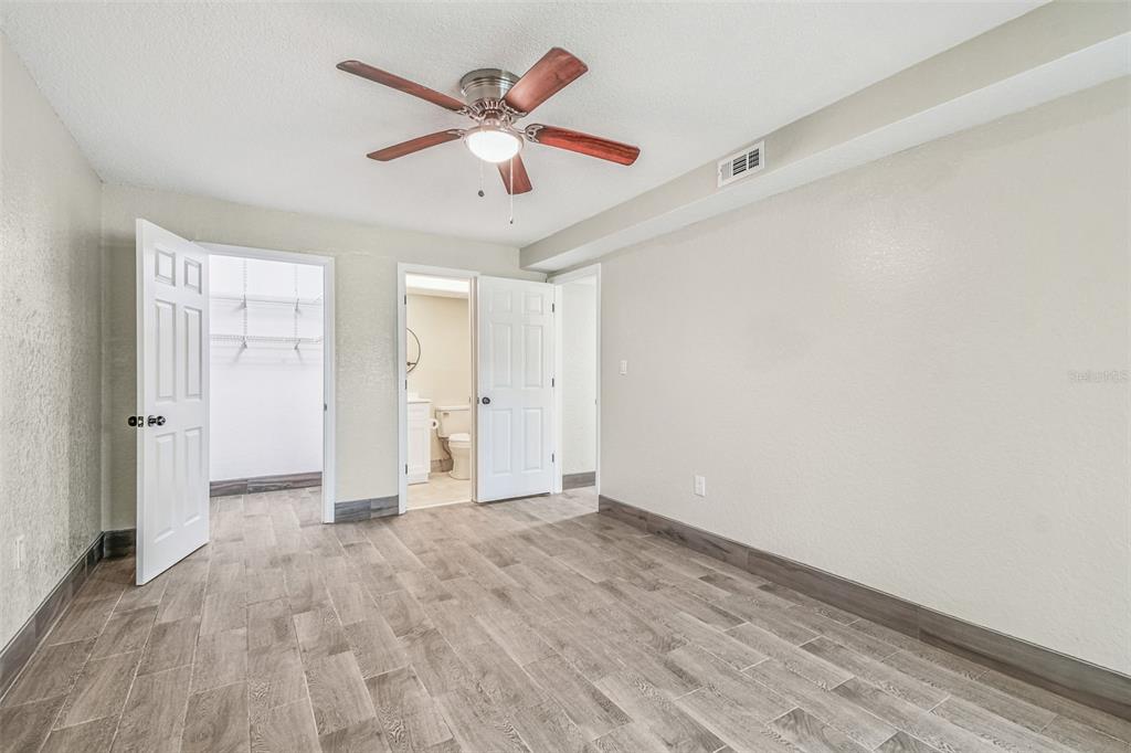 5111 Amulet Drive, Unit 104 New Port Richey, FL 34652 - Photo 34 of 74 wooden floor in an empty room