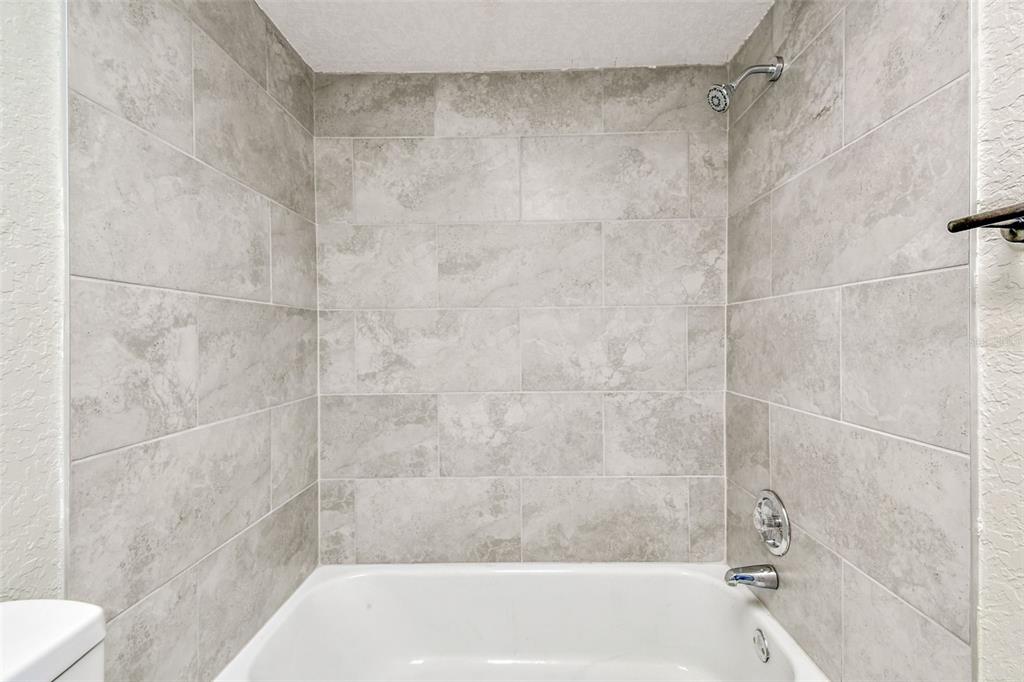 5111 Amulet Drive, Unit 104 New Port Richey, FL 34652 - Photo 39 of 74 a bathroom with a shower and a toilet