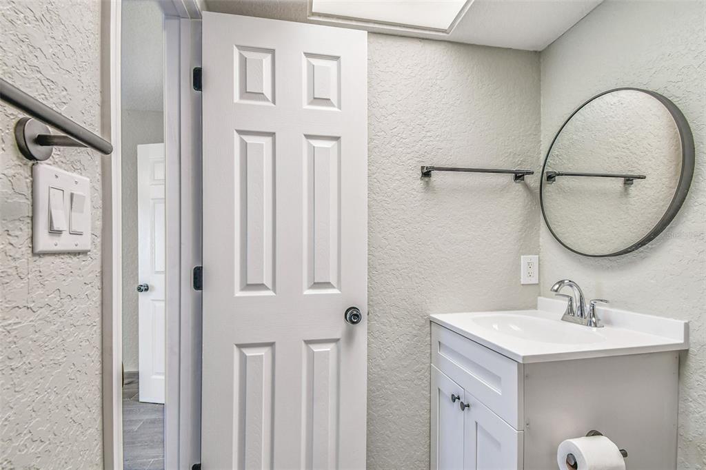 5111 Amulet Drive, Unit 104 New Port Richey, FL 34652 - Photo 40 of 74 a bathroom with a sink and a mirror