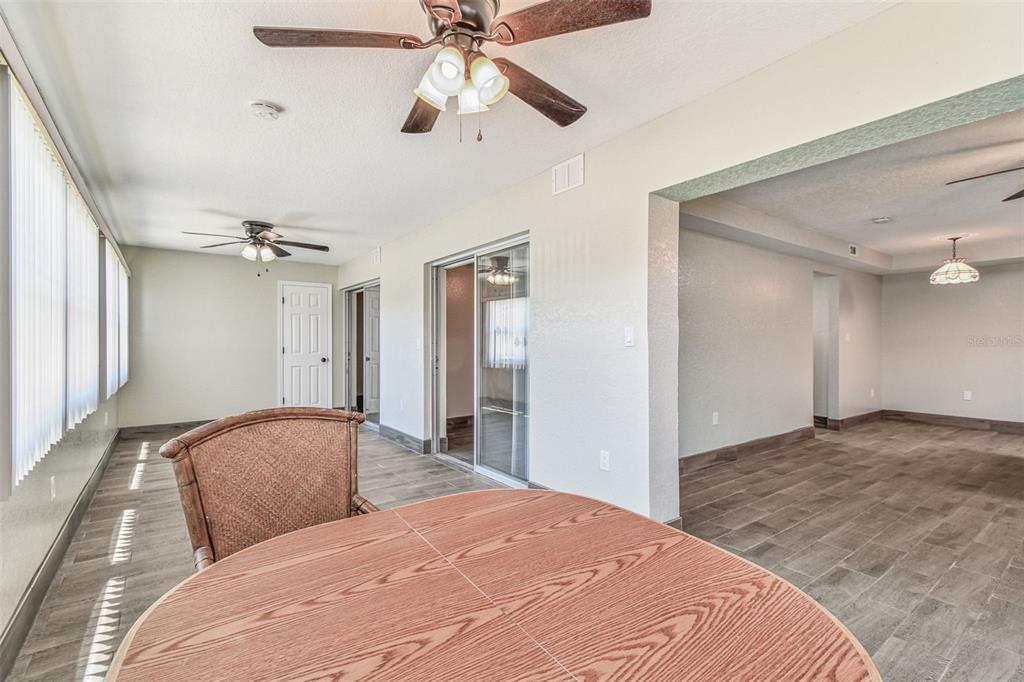 5111 Amulet Drive, Unit 104 New Port Richey, FL 34652 - Photo 44 of 74 a bedroom with a large bed and a chandelier