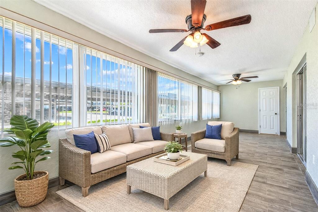 5111 Amulet Drive, Unit 104 New Port Richey, FL 34652 - Photo 5 of 74 a living room with furniture and a large window