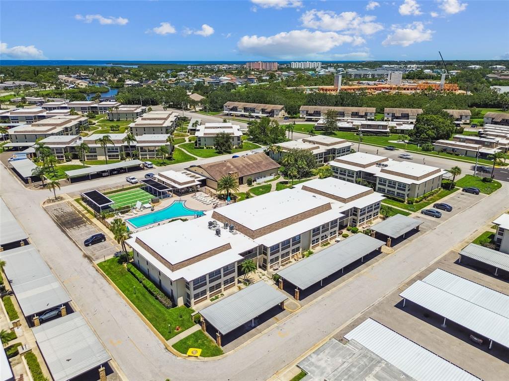 5111 Amulet Drive, Unit 104 New Port Richey, FL 34652 - Photo 53 of 74 an aerial view of a city with lots of residential buildings and ocean view