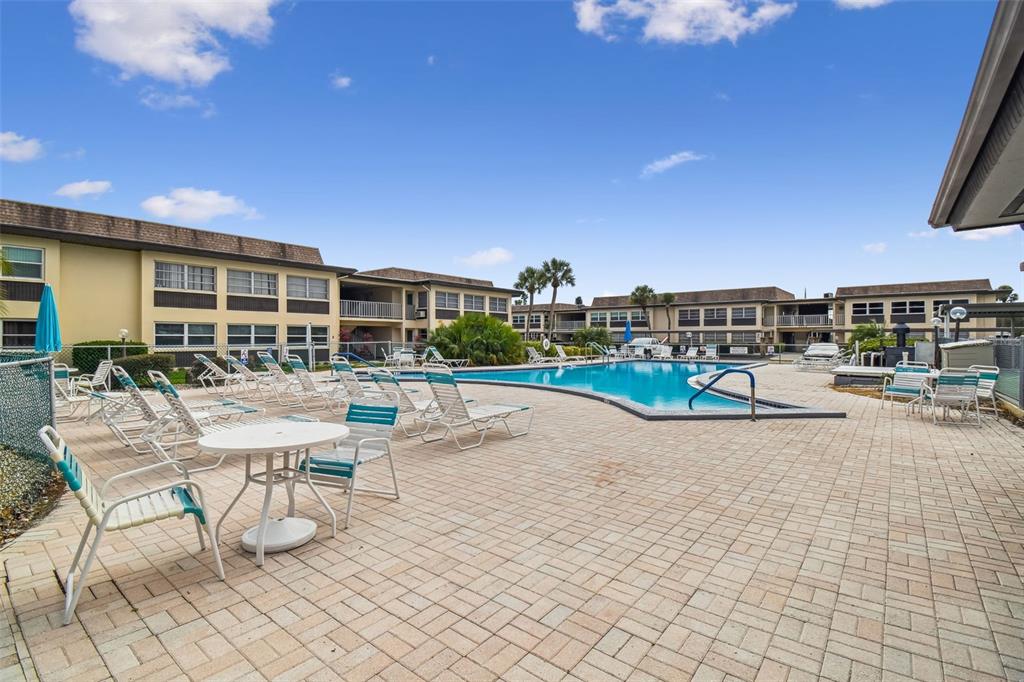 5111 Amulet Drive, Unit 104 New Port Richey, FL 34652 - Photo 59 of 74 a view of a swimming pool with outdoor seating