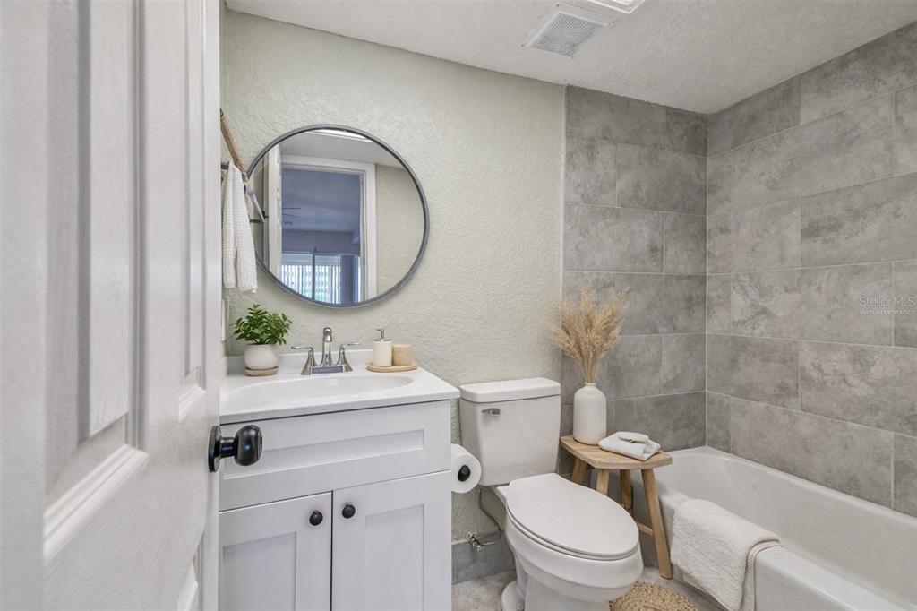 5111 Amulet Drive, Unit 104 New Port Richey, FL 34652 - Photo 8 of 74 a bathroom with a sink a toilet and a mirror