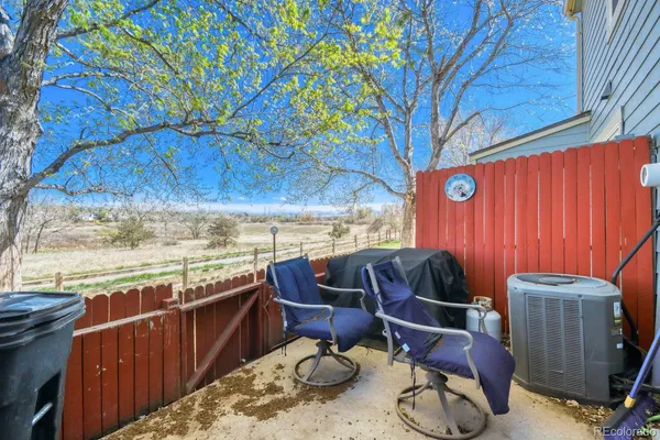 a view of a chairs and table in patio