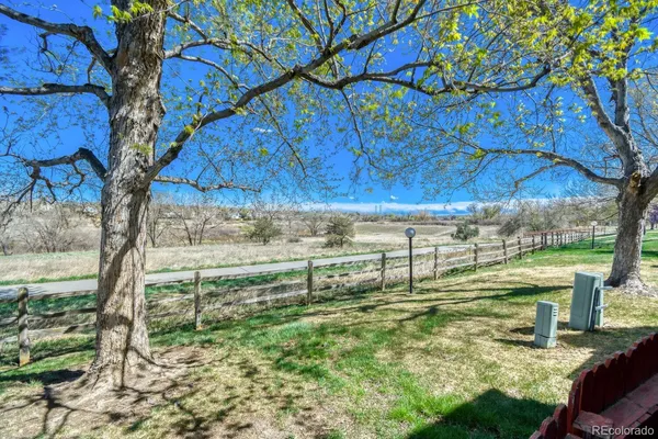 a view of a yard with wooden fence