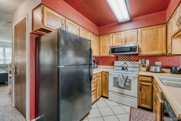 a kitchen with stainless steel appliances a refrigerator sink and cabinets